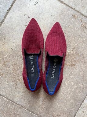 A pair of Rothy's The Point flats in a red/burgundy color